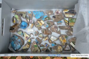 Part of a mixed assemblage of glass mosaic fragments before their reconstruction